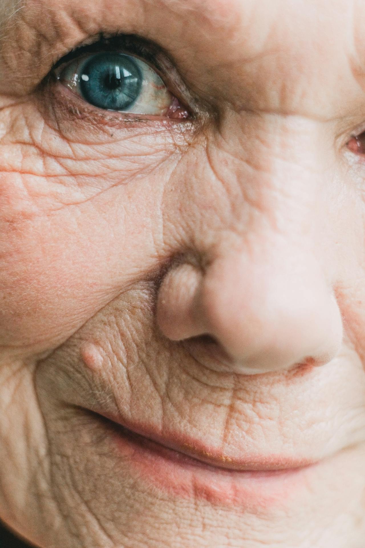 Una mujer mayor emocionalmente abrumada sonriendo | Fuente: Pexels